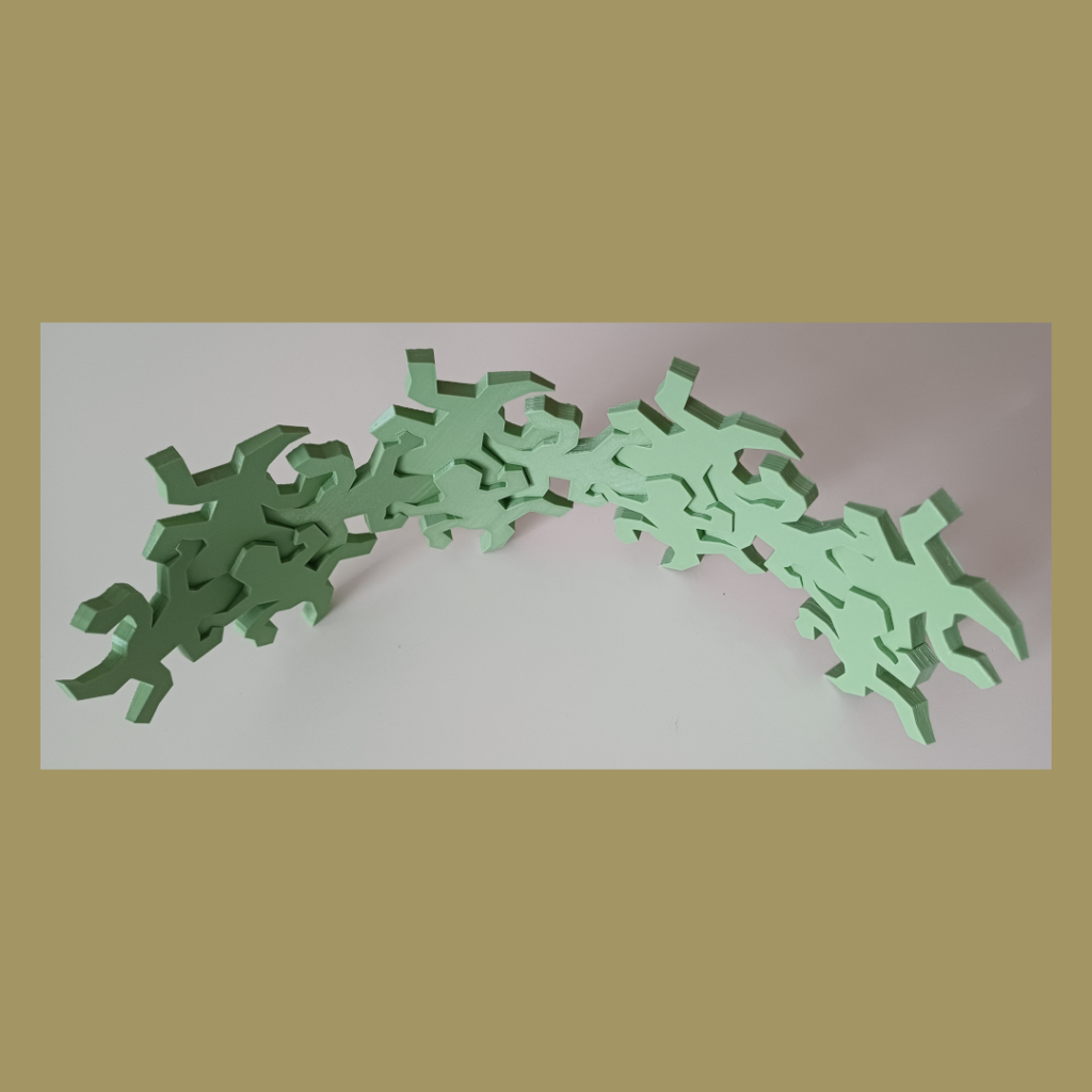 Connected Escher inspired lizards snapped together showing the intended curve used for decoration.
