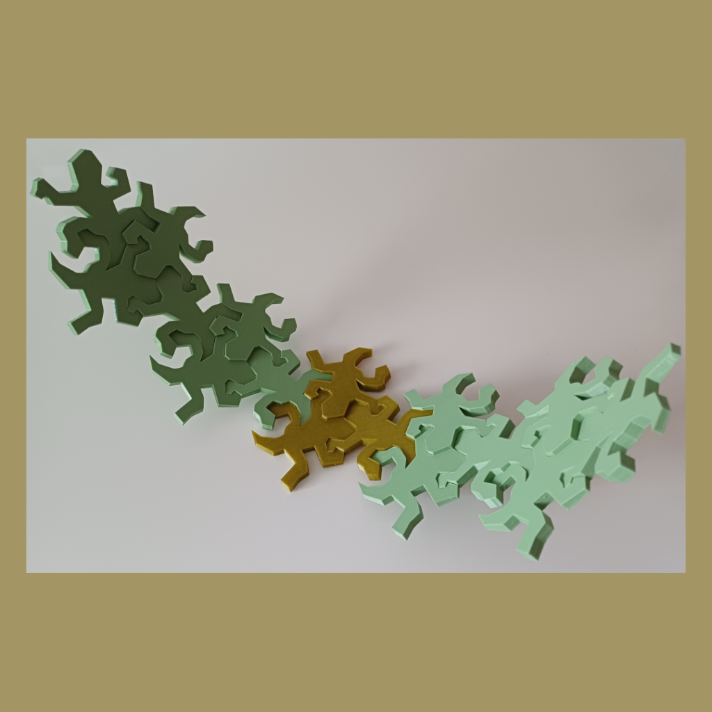 Connected Escher inspired lizards snapped together showing the intended curve used for decoration.