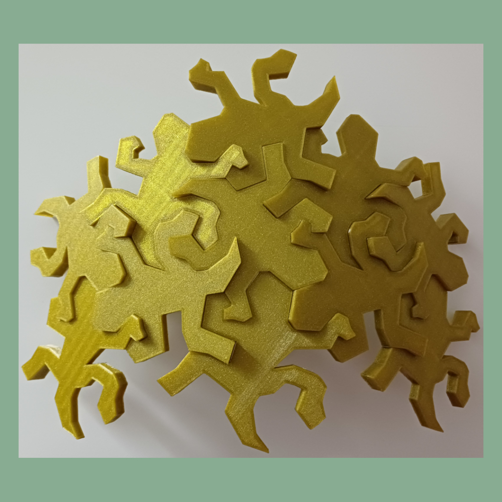 Connected Escher inspired lizards snapped together showing the intended outwards curve used for decoration.