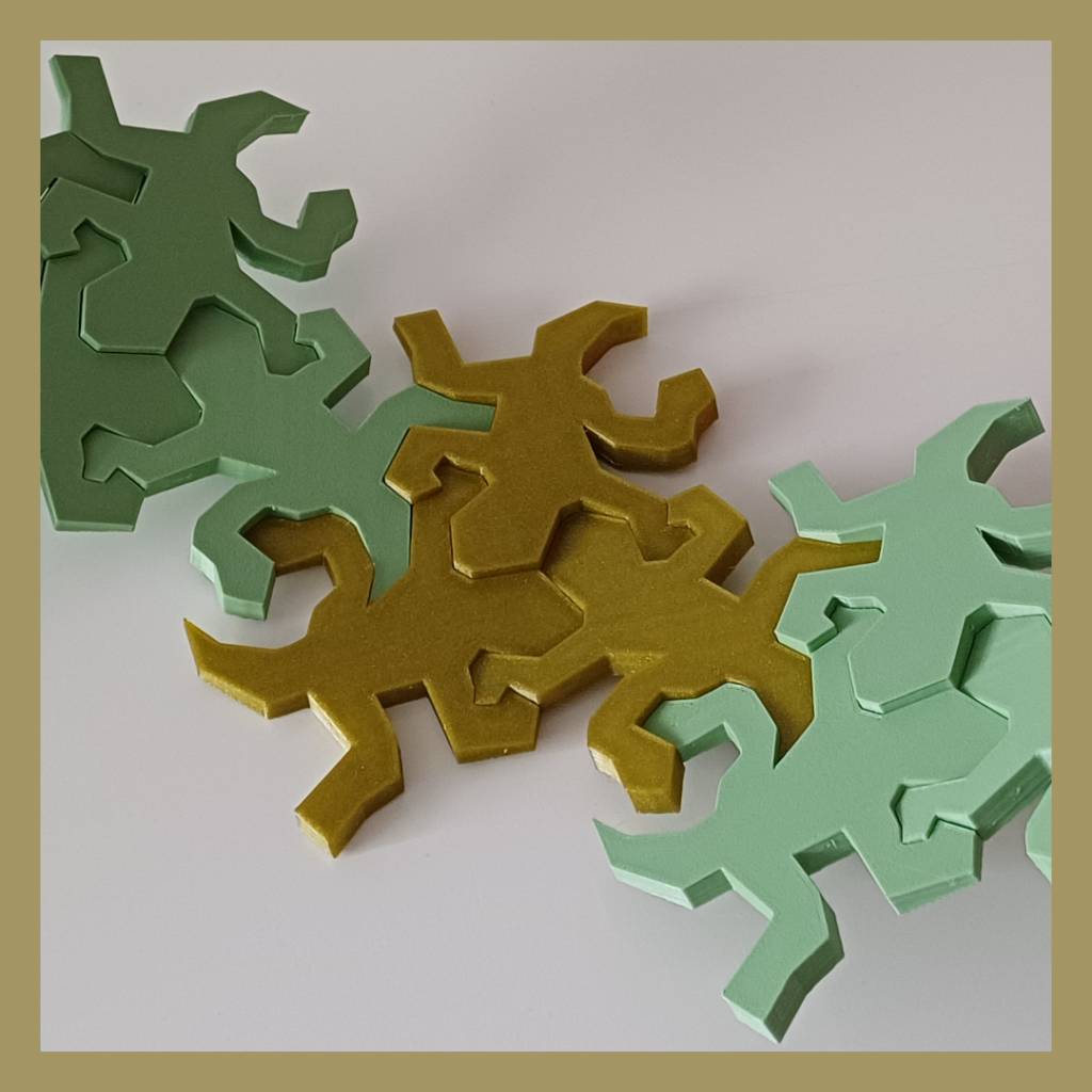 Connected Escher inspired lizards snapped together showing the intended curve details used for decoration.