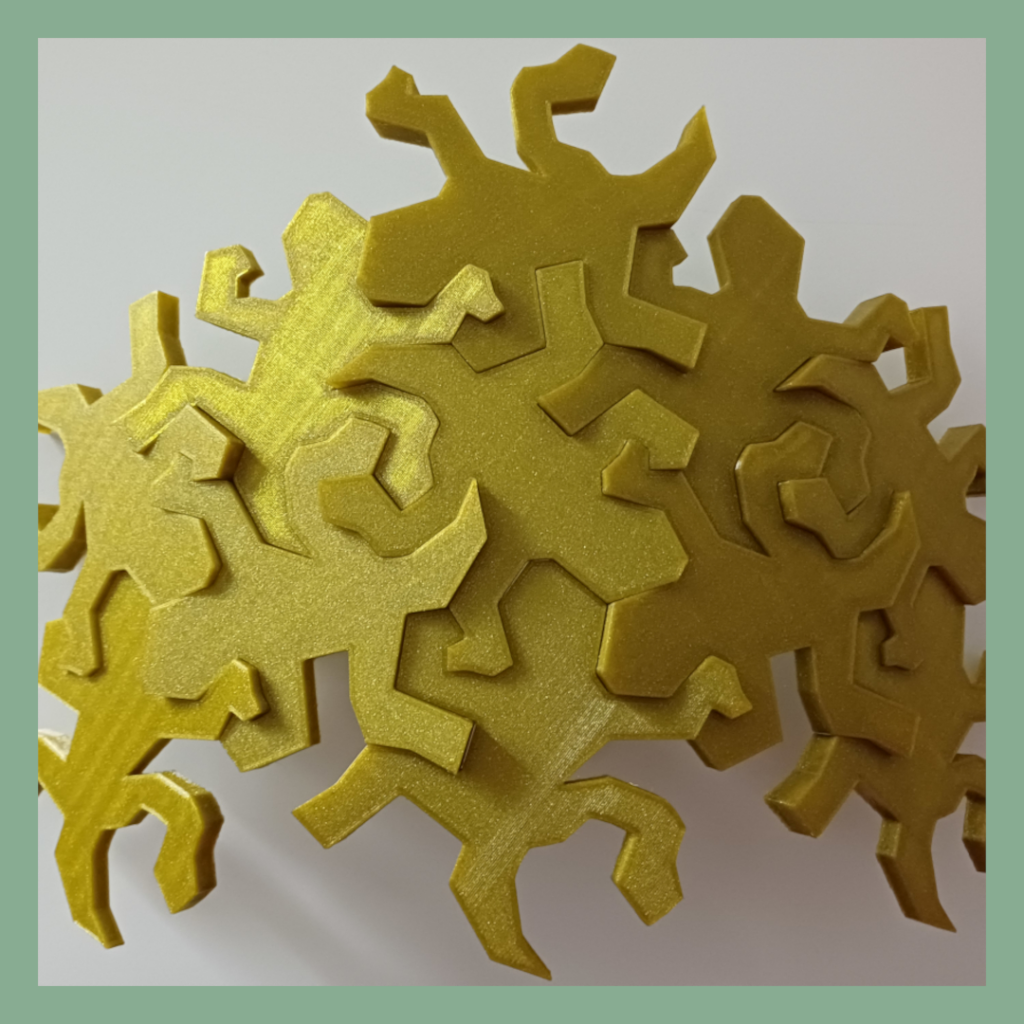 Connected Escher inspired lizards snapped together showing the intended outwards curve details used for decoration.