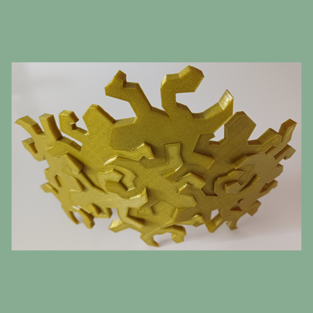 Top view of connected Escher inspired lizards snapped together showing the intended outwards curve used for decoration.